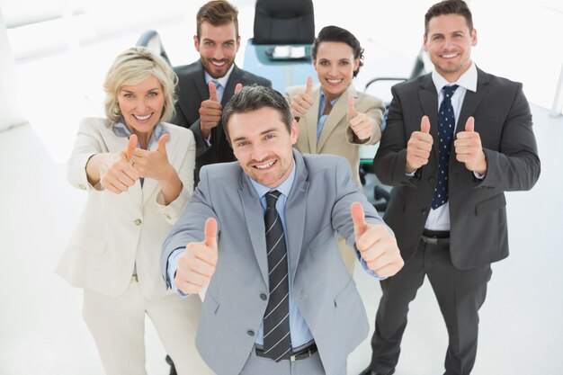 confident-business-team-gesturing-thumbs-up_13339-238835